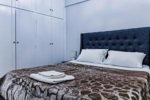 a bedroom with a bed with two towels on it at Messolonghi Holy City in Missolonghi