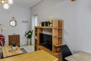 a living room with a fireplace and a table at Messolonghi Holy City in Missolonghi