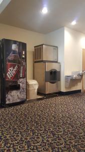 a room with a soda machine with a refrigerator and a microwave at The Rutledge Inn in Luverne +37 photos