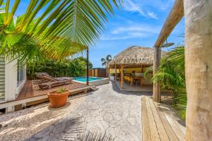 a villa with a swimming pool and a resort at Koeriboeri Aruba Lodges in Babijn
