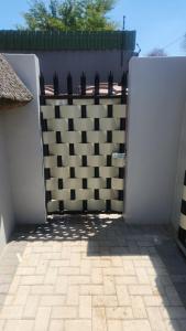 a white gate with a black and white fence at Bootleg Inn in Welkom +3 photos