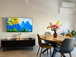 a dining room with a table and a painting on the wall at Caro Studio in Tunari +28 photos