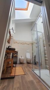a bathroom with a toilet and a desk and a window at Casa Sole - holiday apartment in Maccagno Superiore +35 photos