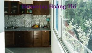 a kitchen with a sink and a window with the words emergency inventory tin at Homestay Hoàng Thi in Phan Thiet +55 photos