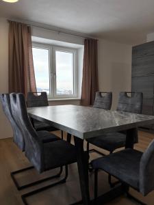 a dining room with a large table and chairs at Mühlviertler Auszeit in Pisling