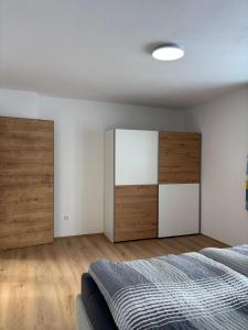 a bedroom with a bed and wooden cabinets at Mühlviertler Auszeit in Pisling