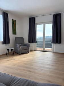 a living room with a chair and a window at Mühlviertler Auszeit in Pisling