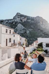 a group of people sitting at a table on the stairs at Casita Capricho in Zuheros