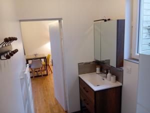 a bathroom with a sink and a mirror at Magnifique et Grand T3 au cœur de la Normandie in Saint-Victor-lʼAbbaye +10 photos