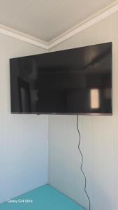 a flat screen tv hanging on a wall at Anastasi Tiny Homes- Mountain Views, Garden & Terrace, Pet Friendly in Kakopetria