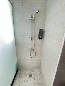 a shower with a shower head in a bathroom at Aliwan 小路彎彎 in Taitung City +12 photos