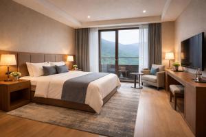 a hotel room with a bed and a large window at Travellers Story Baga GOA in Baga
