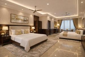 a large bedroom with two beds and a television at Travellers Story Baga GOA in Baga