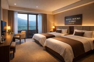 a hotel room with two beds and a television at Travellers Story Baga GOA in Baga +2 photos