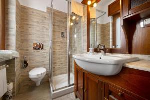 a bathroom with a sink and a shower and a toilet at Welcome Home 2 vista Rocciamelone in Meana di Susa +31 photos