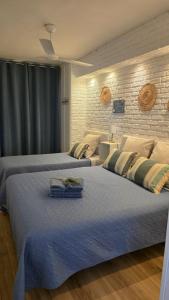 a bedroom with two beds and a brick wall at Brisa al Mar in Bellreguart +21 photos