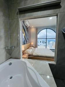 a bathroom with a bath tub and a bedroom at Villa Suarga Loka in Tutugan +3 photos