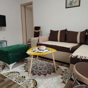 a living room with a couch and a table at Apartman5 in Gornja Toplica