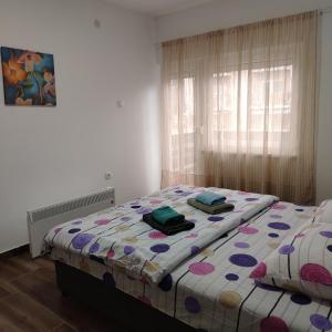 a bedroom with a bed with two towels on it at Apartman5 in Gornja Toplica