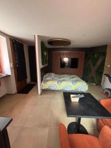 a bedroom with a bed and a table in it at esperanza in Vizille