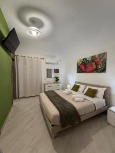 a bedroom with a large bed in a room at Trinacria Rooms 1 in Carini