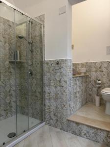 a bathroom with a shower and a toilet at Trinacria Rooms 1 in Carini