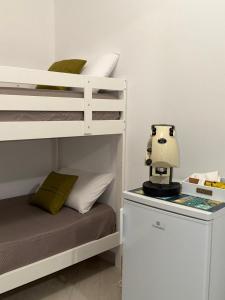 a small bedroom with a bunk bed with a sewing machine at Trinacria Rooms 1 in Carini