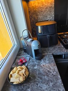 a table with a plate of cookies and a cake at Baltijos Apartamentai, Self check-in, free parking in Klaipėda +13 photos