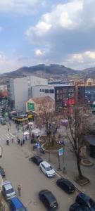a city with cars parked in a parking lot at Home NP Apartments in Novi Pazar
