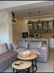 a living room with a couch and a table at KANALI HOLIDAYS APARTMENT 5 in Preveza
