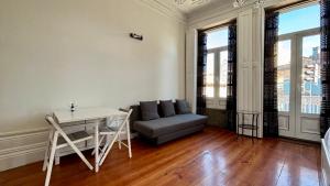 a living room with a couch and a table at Pombeiro Apartments in Porto