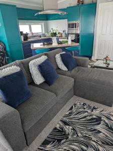 a living room with a brown couch and blue walls at Unique 2 bed lodge lyons Robinhood in Rhyl