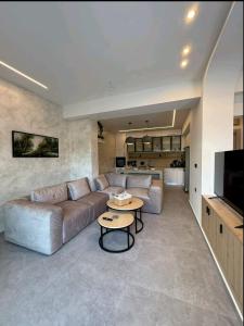 a living room with a couch and a table at KANALI HOLIDAYS APARTMENT 5 in Preveza
