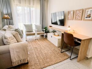 a living room with a couch and a table and a tv at The Halfway Homestead in Middelburg +33 photos