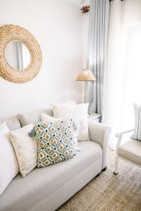 a living room with a couch and a mirror at The Halfway Homestead in Middelburg