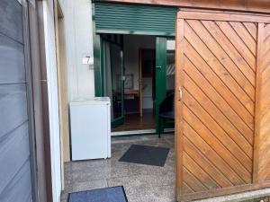 an entrance to a house with a wooden door at Pension Hammoor in Hammoor