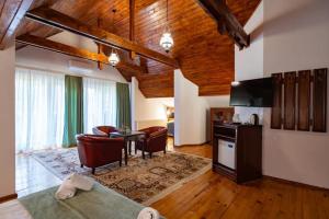 a kitchen and living room with a table and chairs at Vila Zorile in Poiana Brasov