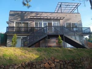 a house with a staircase in front of it at Shans Valley in Kotagiri