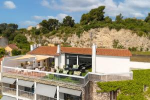an aerial view of a building with a balcony at Cit'Hotel L'Oasis d'Avignon in Villeneuve-lès-Avignon
