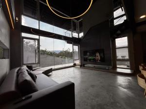 a living room with a couch and a tv at Aernan Inn in Yuchi