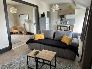a living room with a couch and a table at Private studio in Loft in Tarbes in Tarbes