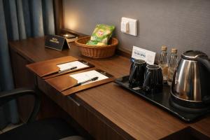 a table with a tray with a tea kettle on it at Blue Diamond Residency in Perintalmanna