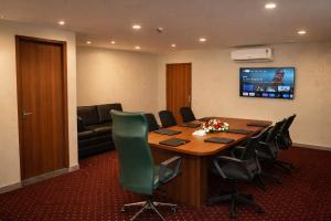 a conference room with a large wooden table and chairs at Blue Diamond Residency in Perintalmanna