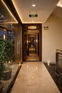 a hallway in a building with a sign that reads exit at Blue Diamond Residency in Perintalmanna
