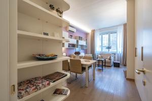 a living room with a table and a dining room at Cavour Suite Luxury in Bologna