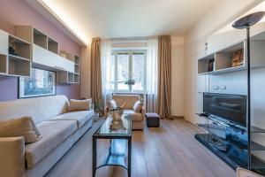 a living room with a couch and a tv at Cavour Suite Luxury in Bologna