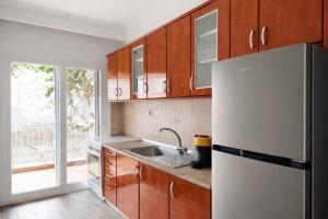a kitchen with a refrigerator and a sink at Ethereal Beach House in Hanioti