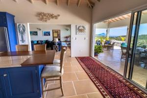 a dining room and living room with a table and chairs at Tuckers Villa in Cobbs Cross