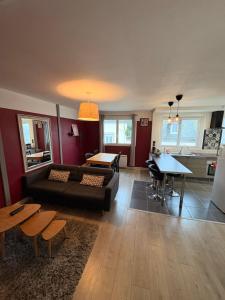 a living room with a couch and a table at Appartement Duplex The Lighthouse in Châteaulin