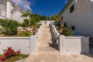a stairway leading up to a white building at Tuckers Villa in Cobbs Cross